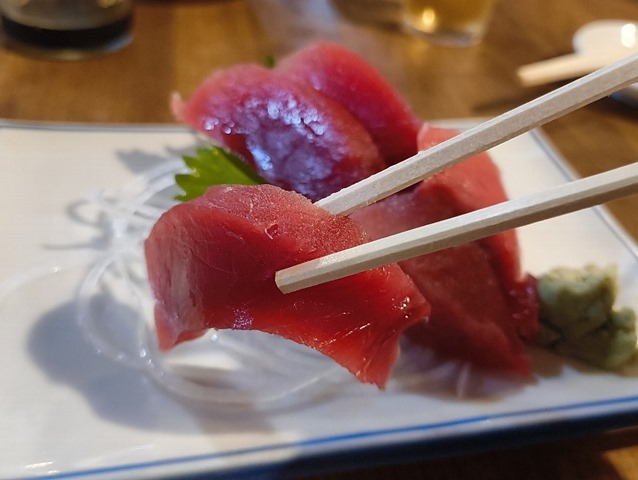 マグロの刺身を食べる