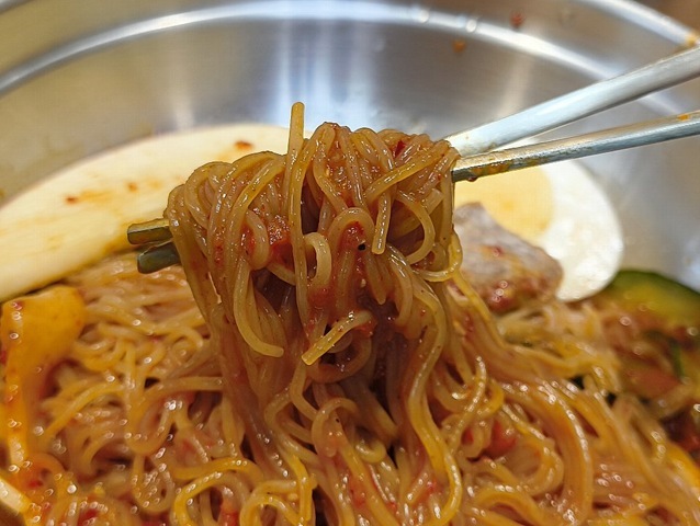 赤く染まった麺を口に運ぶ