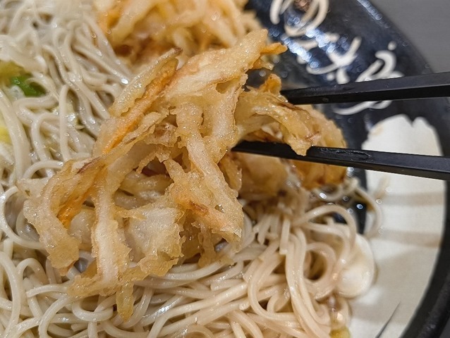 ふにゃふにゃになったかきあげを食べる